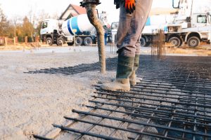 Concrete worker laying a foundation for a business in Lakeway